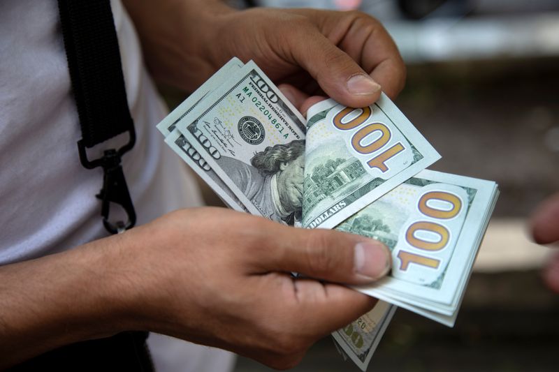 Dollar edges higher ahead of payrolls release; euro slips lower