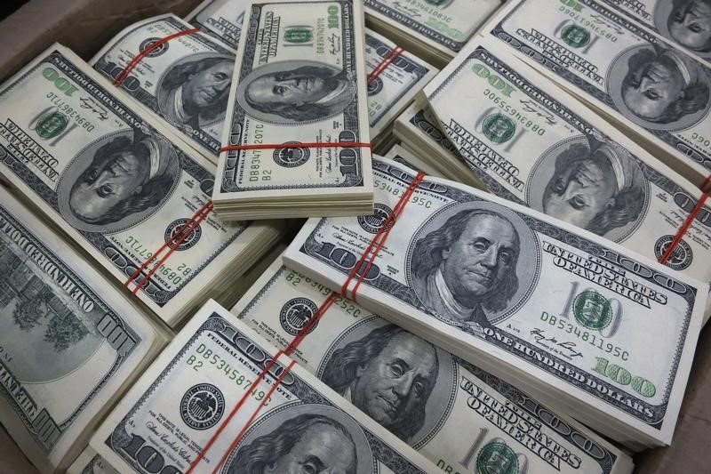 Dollar slips but on track for hefty weekly gains