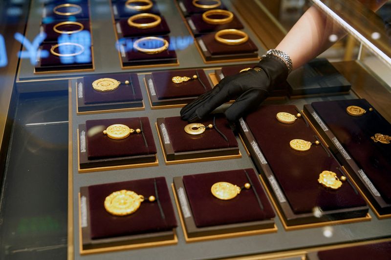 Gold slips on stronger dollar, market awaits US inflation data