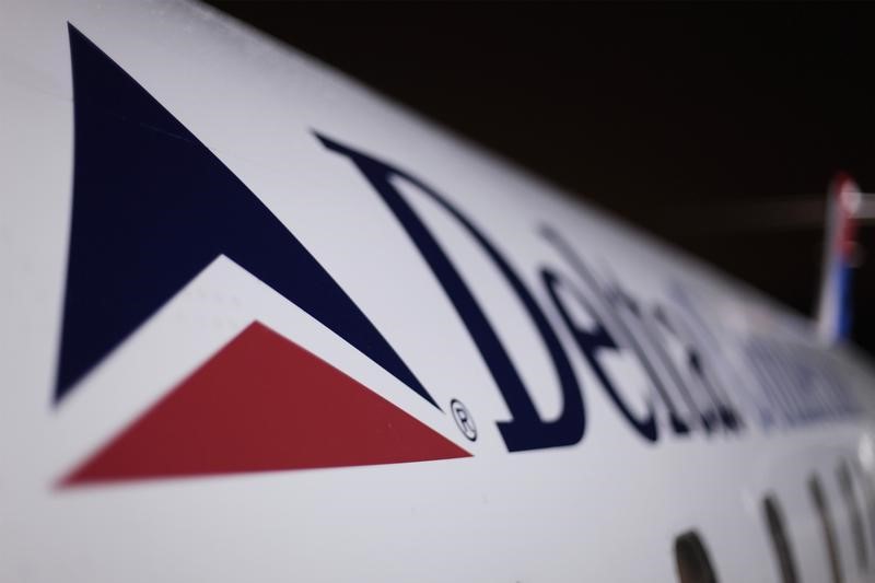 Delta, Apple, Domino's Pizza fall premarket; Tesla, GXO Logistics rise