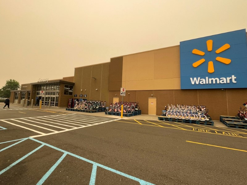 Walmart boosts sales outlook, shares surge to record